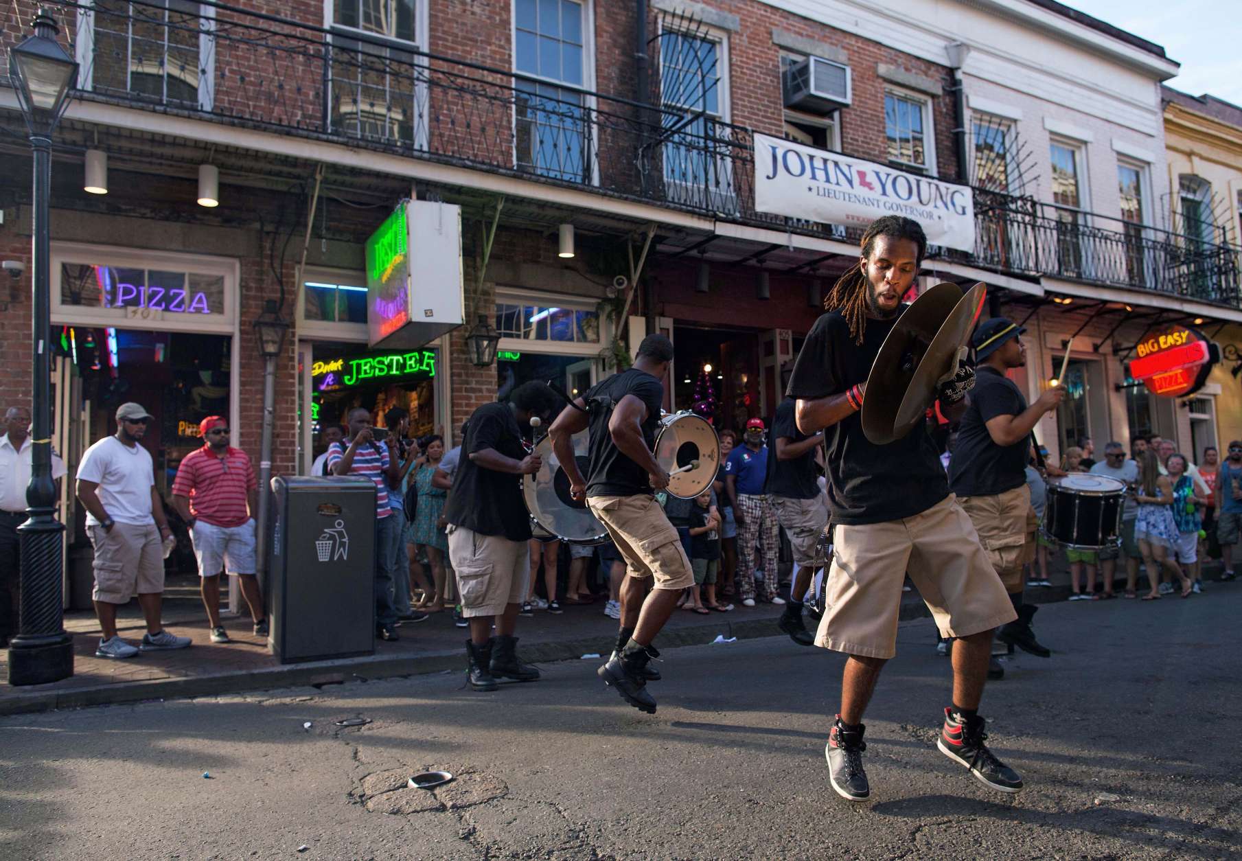 A percussion band performs for tourist dollars on Bourbon Street in the French Quarter of New Orleans, Saturday, Aug. 15, 2015. New Orleans is nearly three centuries old, mixing African-American, French, Spanish and Caribbean traditions to create unique forms of music, food and culture found nowhere else in America. (AP Photo/Max Becherer)
