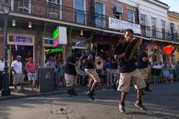 A percussion band performs for tourist dollars on Bourbon Street in the French Quarter of New Orleans, Saturday, Aug. 15, 2015. New Orleans is nearly three centuries old, mixing African-American, French, Spanish and Caribbean traditions to create unique forms of music, food and culture found nowhere else in America. (AP Photo/Max Becherer)