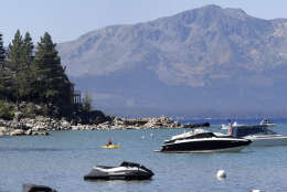 FILE -- In this Aug. 24, 2015 file photo, a kayaker paddles along Zephyr Cove, the sight of the 19th Annual Lake Tahoe Summit Monday, Aug. 24, 2015.  The summit brought together lawmakers,  including Calif. Gov. Jerry Brown, U.S. Sens. Dean Heller, R-Nev., and Dianne Feinstein, D-Calif., other government officials, , business leaders and environmentalists to  the the two-day summit to discuss this years theme, "Connecting Lake Tahoe's Environment and Economy throughout Innovation and Transportation."  Brown has made climate change the centerpiece of his final tenure by trying to reduce California's carbon footprint and boost the state's renewable energy use to 50 percent in 15 years, if he can get it approved by fellow Democrats in the state Legislature.(AP Photo/Rich Pedroncelli, file)