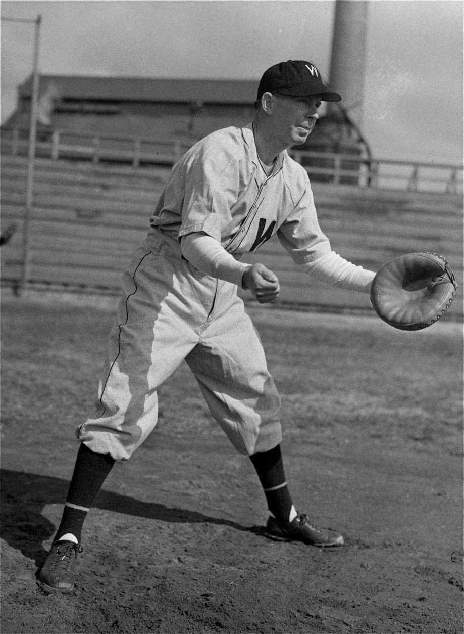 Rick Ferrell, veteran catcher, limbers up as he joins the Washington Senators' spring training camp at the University of Maryland's field at College Park, Md., March 14, 1944.  (AP Photo)