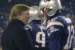 Donald Trump, left, stops to talk to New England Patriots quarterback Tom Brady prior to the start of the game at Gillette Stadium, Saturday, Jan. 10, 2004, in Foxborough, Mass., where the Patriots will play the Tennessee Titans in a AFC divisional playoff game. (AP Photo/Elise Amendola)