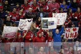 Washington Capitals fan hold signs for their team in the third period of an NHL hockey game against the Buffalo Sabres, Sunday, Jan. 12, 2014, in Washington. The Sabres won 2-1 in a shootout. (AP Photo/Alex Brandon)