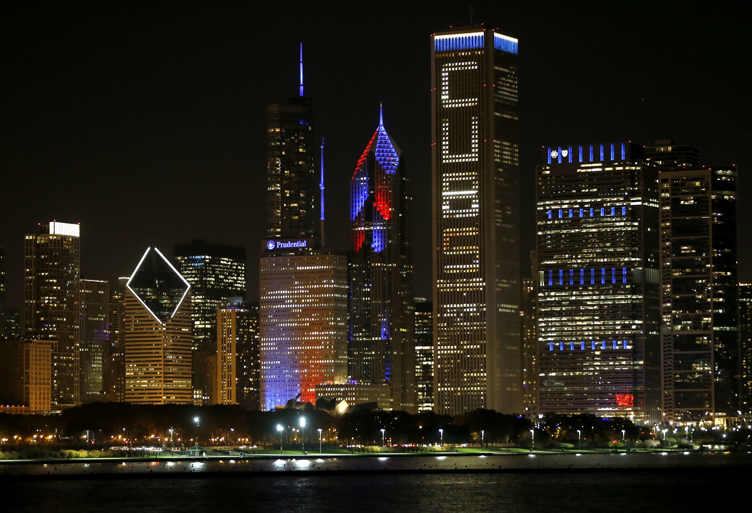 The Chicago skyline is lit with supportive window messages for Chicago Cubs fans after an earlier rally in Grant Park honoring the World Series baseball champions, Friday, Nov. 4, 2016. (AP Photo/Charles Rex Arbogast)