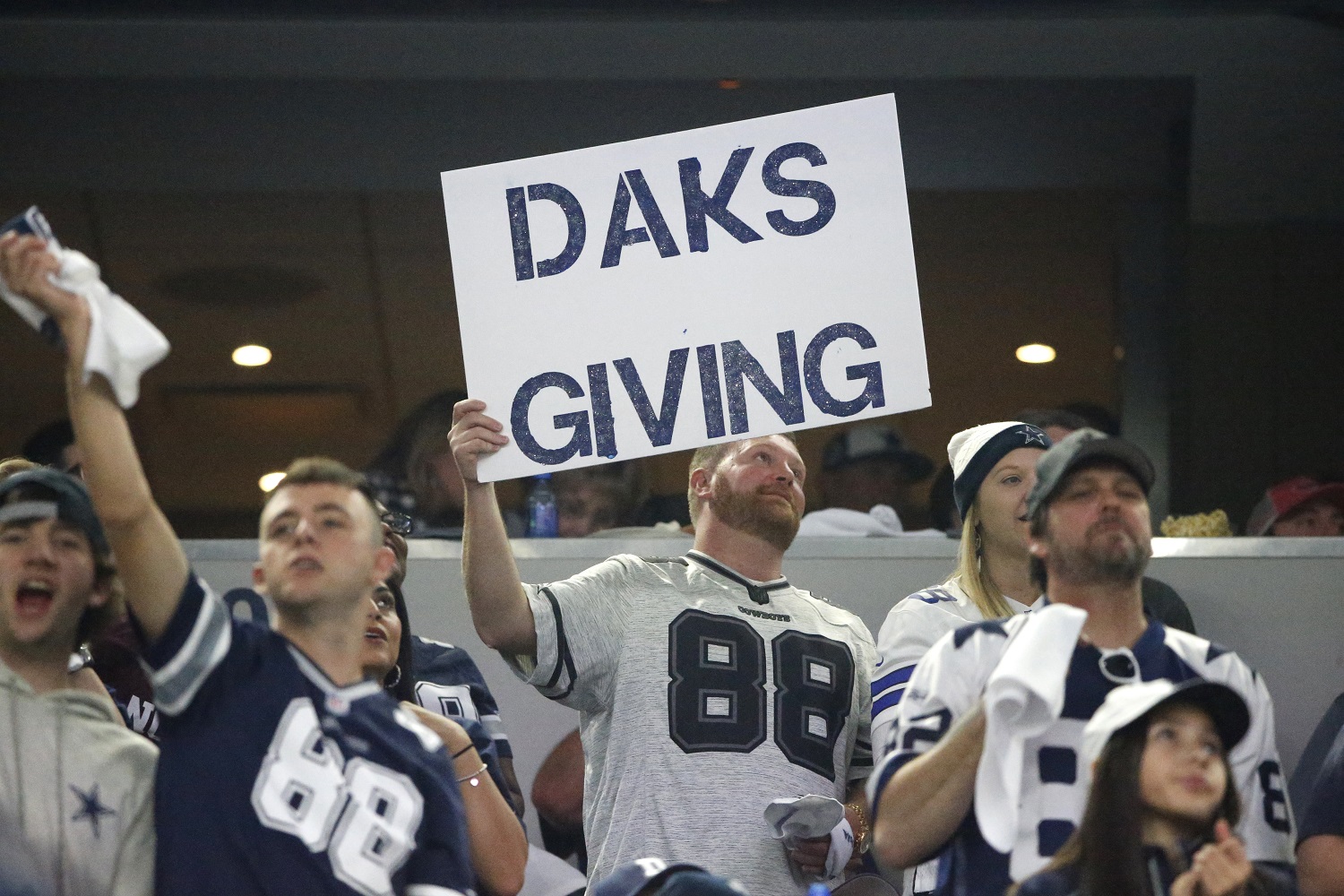 A Dallas Cowboys fan holds up a sign referring to quarterback Dak Prescott and the Thanksgiving holiday during an NFL football game against the Washington Redskins on Thursday, Nov. 24, 2016, in Arlington, Texas. (AP Photo/Ron Jenkins)