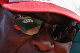 FILE - In this March 23, 2016, file photo, the team logo on the playing field is reflected in the sunglasses of Washington Nationals manager Dusty Baker as he talks with players during batting practice before a spring training baseball game against the New York Yankees in Viera, Fla. Baker said his No. 1 priority was players staying healthy, especially after the Nationals developed something of a reputation as an injury-prone bunch. (AP Photo/John Raoux, File)