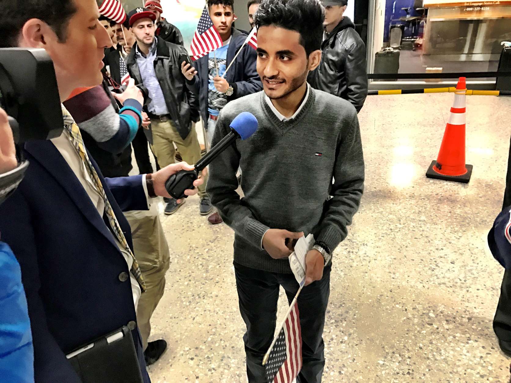 Tareq Aziz, 21, native of Yemen with a green card, arrives back in the U.S. at Dulles international Airport on Monday, along with his brother Ammar. (WTOP/Neal Augenstein)