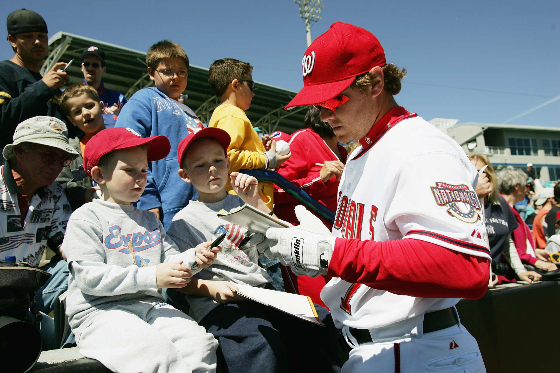 VIERA, FL - MARCH 2:  Infielder Brad Wilkerson #7 of the Washington Nationals signs autographs for brothers Kyle Ross, five-years-old and Paulie Ross, seven-years-old, of Merrit Island, Florida prior to the game against the New York Mets during MLB Spring Training action on March 2, 2005 at the Space Coast Stadium in Viera, Florida. The Washington Nationals defeated the New York Mets 5-3. (Photo by Doug Pensinger/Getty Images)