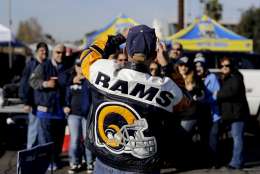 A Los Angeles Rams fans talks a group picture in the parking lot before an NFL football game against the Arizona Cardinals Sunday, Jan. 1, 2017, in Los Angeles. (AP Photo/Jae C. Hong)