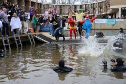 The dry onlookers cheered from the plaza as plungers — some solo, some in groups; some tentatively, some with backflips and cannonballs — took the chilly dive. (Courtesy Reston Now)