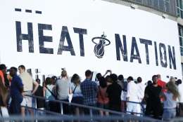 Basketball fans line up outside the American Airlines Arena before the start of Game 5 of an NBA basketball playoffs first-round series between the Miami Heat and the Charlotte Hornets, Wednesday, April 27, 2016, in Miami. (AP Photo/Wilfredo Lee)