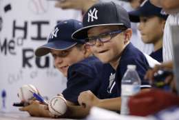 New York Yankees fans watch Yankees players warm up prior to a baseball game against the Arizona Diamondbacks Tuesday, May 17, 2016, in Phoenix. (AP Photo/Ross D. Franklin)