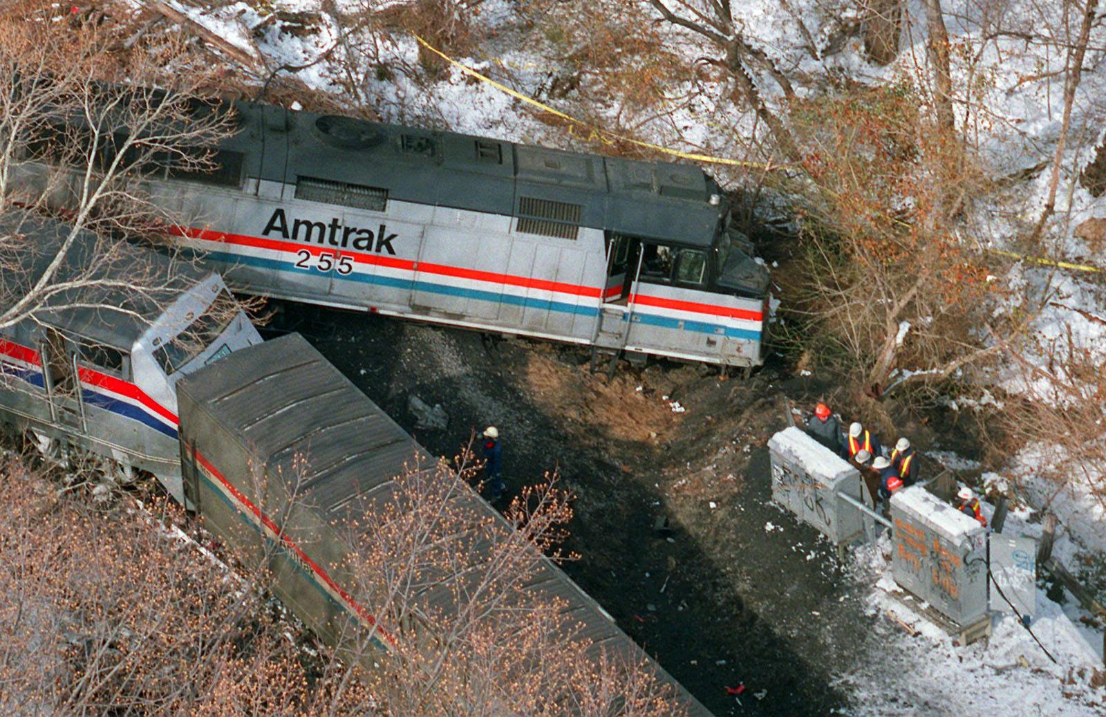 The Amtrak locomotive that hit a MARC commuter train Friday night, killing at least 11 people, is seen in this aerial view Saturday, Feb. 17, 1996 in Silver Spring, Md. At right, workers inspect signal switching equipment. (AP Photo/Doug Mills)