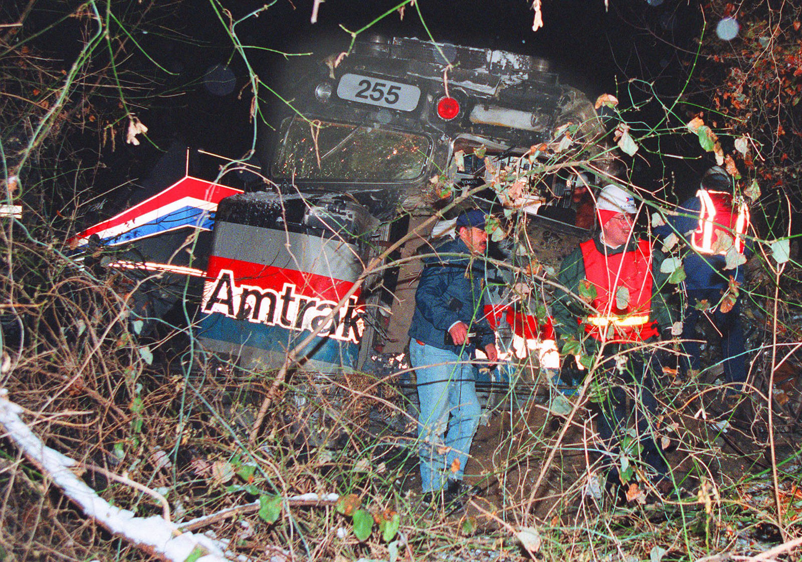 Investigators look over the front engine of the Amtrak train that collided with a MARC commuter train during a snow storm Friday, Feb. 16, 1996 in Silver Spring, Md. At least 12 people were killed and a score were injured. (AP Photo/Ruth Fremson)