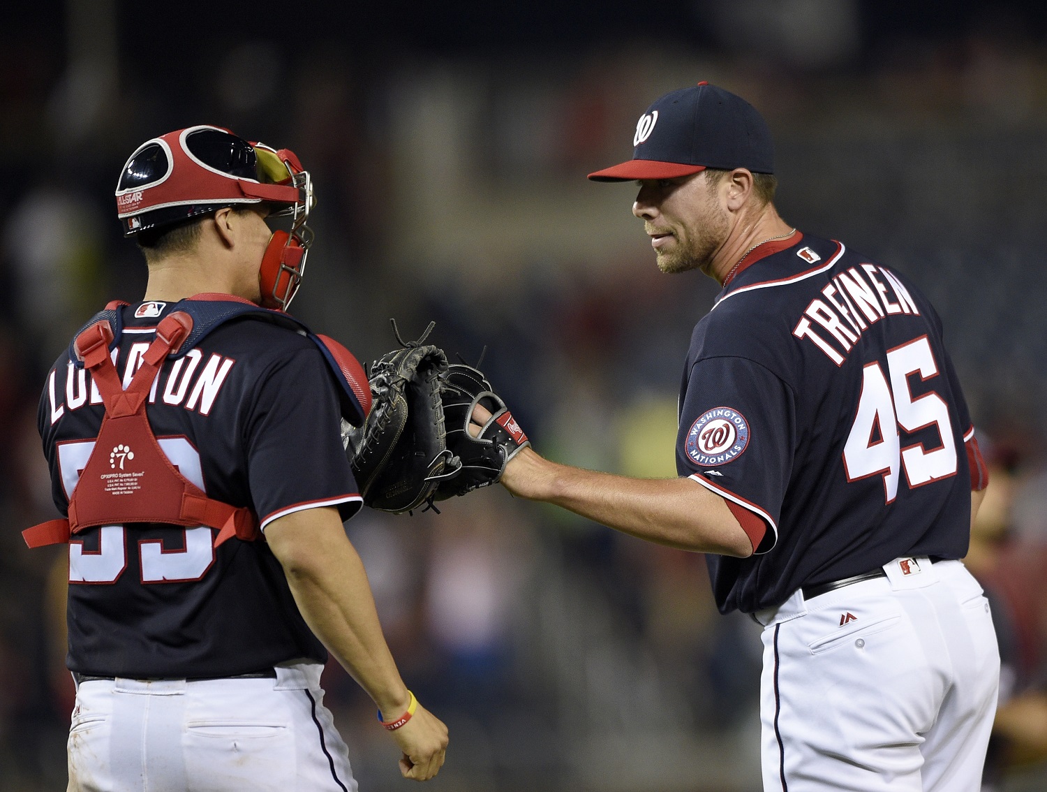 Washington Nationals relief pitcher Blake Treinen (45) celebrates with catcher Jose Lobaton (59) after the Nationals defeated the Minnesota Twins 8-4 in a baseball game Friday, April 22, 2016, in Washington. (AP Photo/Nick Wass)