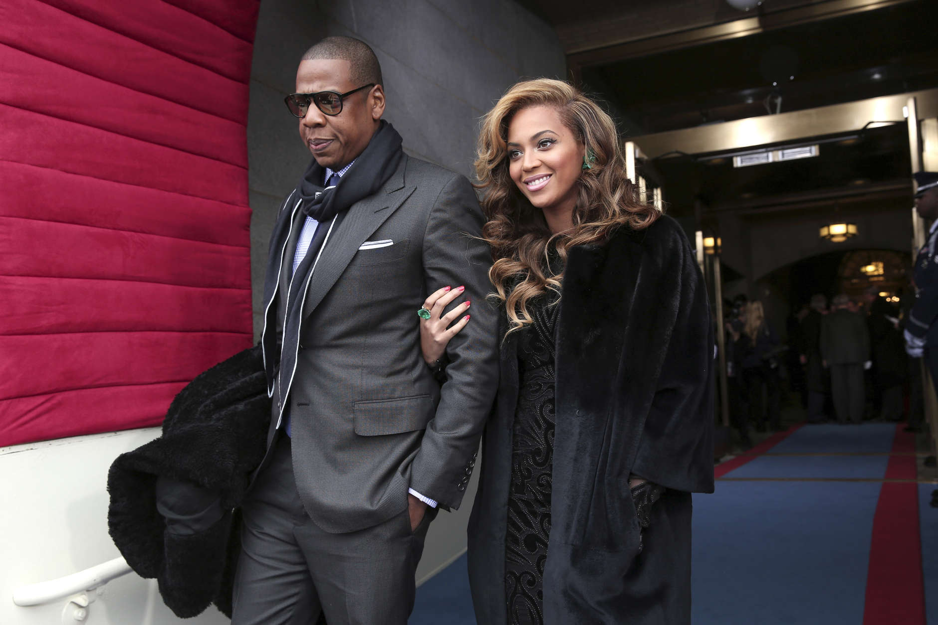 Recording artists Jay-Z and Beyonce arrive on the West Front of the Capitol in Washington, Monday, Jan. 21, 2013, for the Presidential Barack Obama's ceremonial swearing-in ceremony during the 57th Presidential Inauguration.  (AP Photo/Win McNamee, Pool)