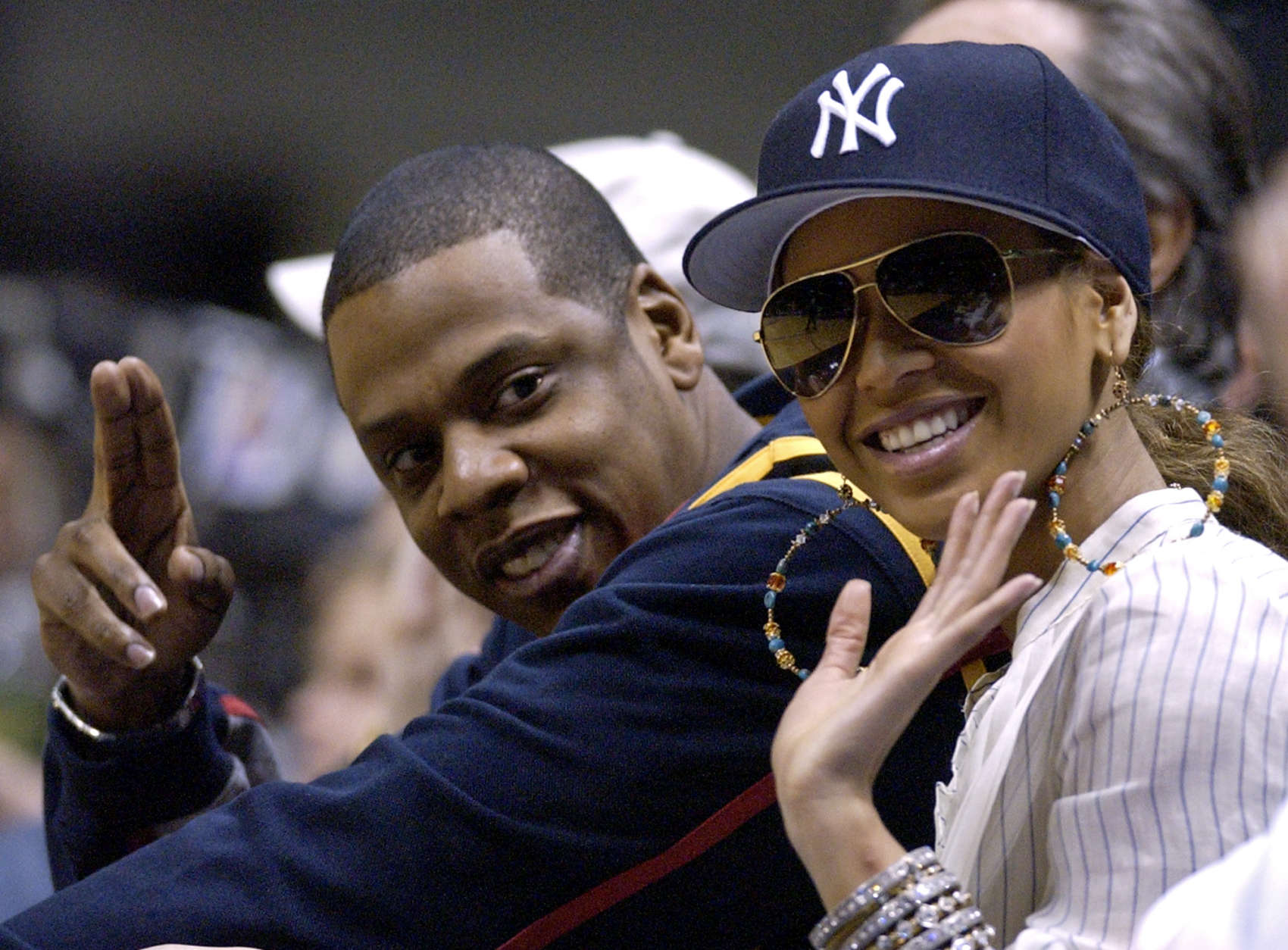 Jesse Itzler, Co-founder of Marquis Jet, and Jay-Z (R) smile and react  while the New York Yankees play the Cleveland Indians in game 4 of the ALDS  at Yankee Stadium in New