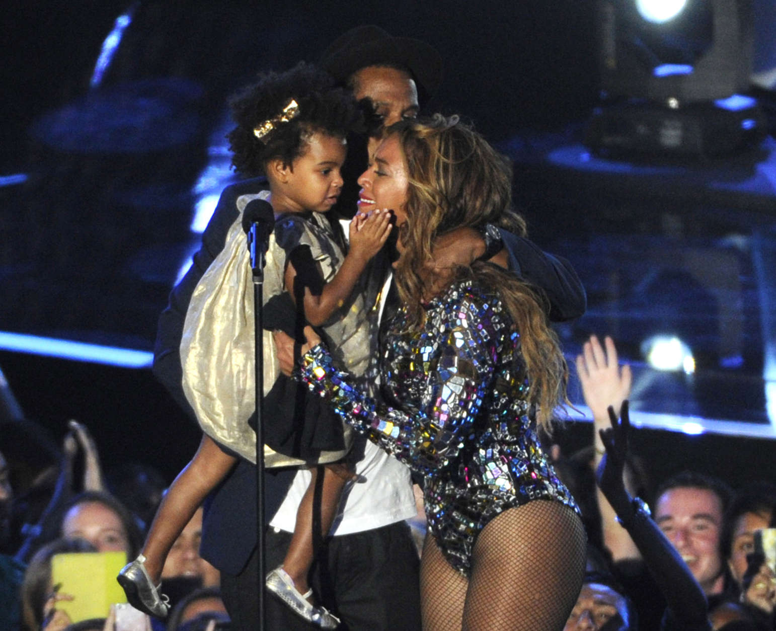 FILE - In this Sunday, Aug. 24, 2014 file photo, Beyonce on stage hugs Jay Z and their daughter Blue Ivy as she accepts the Video Vanguard Award at the MTV Video Music Awards at The Forum, in Inglewood, Calif. BET has suspended a producer after a joke about Blue Ivys hair aired Monday, Aug. 25, 2014, on the networks music video countdown show, 106 &amp; Park. A source at the network, who spoke on the condition of anonymity because the person was not allowed to discuss the matter publicly, said the producer was suspended after the ill-fitting joke about Beyonce and Jay Zs two-year-old daughter aired. (Photo by Chris Pizzello/Invision/AP, file)
