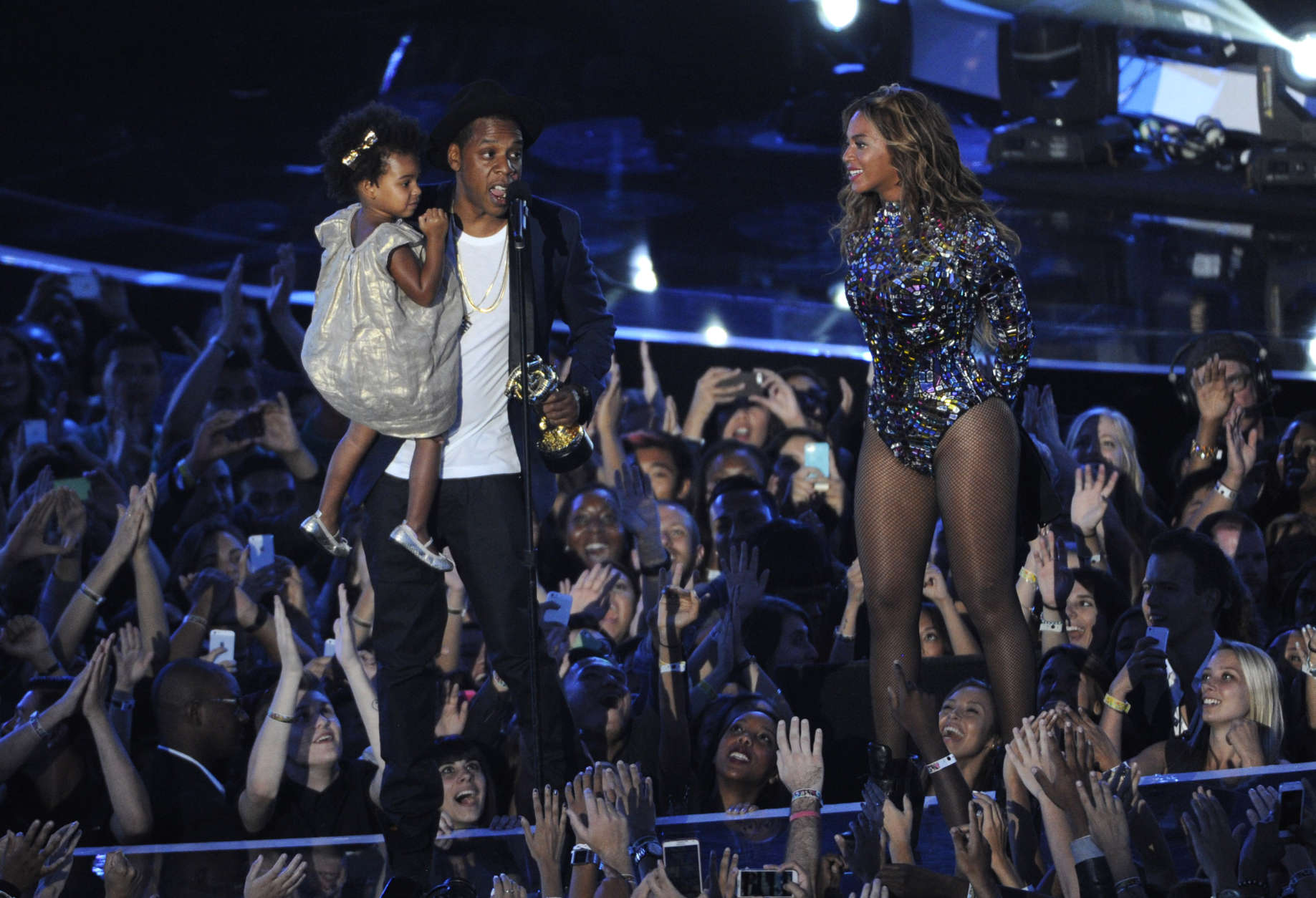 Beyonce on stage with Jay Z and their daughter Blue Ivy as she accepts the Video Vanguard Award at the MTV Video Music Awards at The Forum on Sunday, Aug. 24, 2014, in Inglewood, Calif. (Photo by Chris Pizzello/Invision/AP)