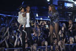 Beyonce on stage with Jay Z and their daughter Blue Ivy as she accepts the Video Vanguard Award at the MTV Video Music Awards at The Forum on Sunday, Aug. 24, 2014, in Inglewood, Calif. (Photo by Chris Pizzello/Invision/AP)