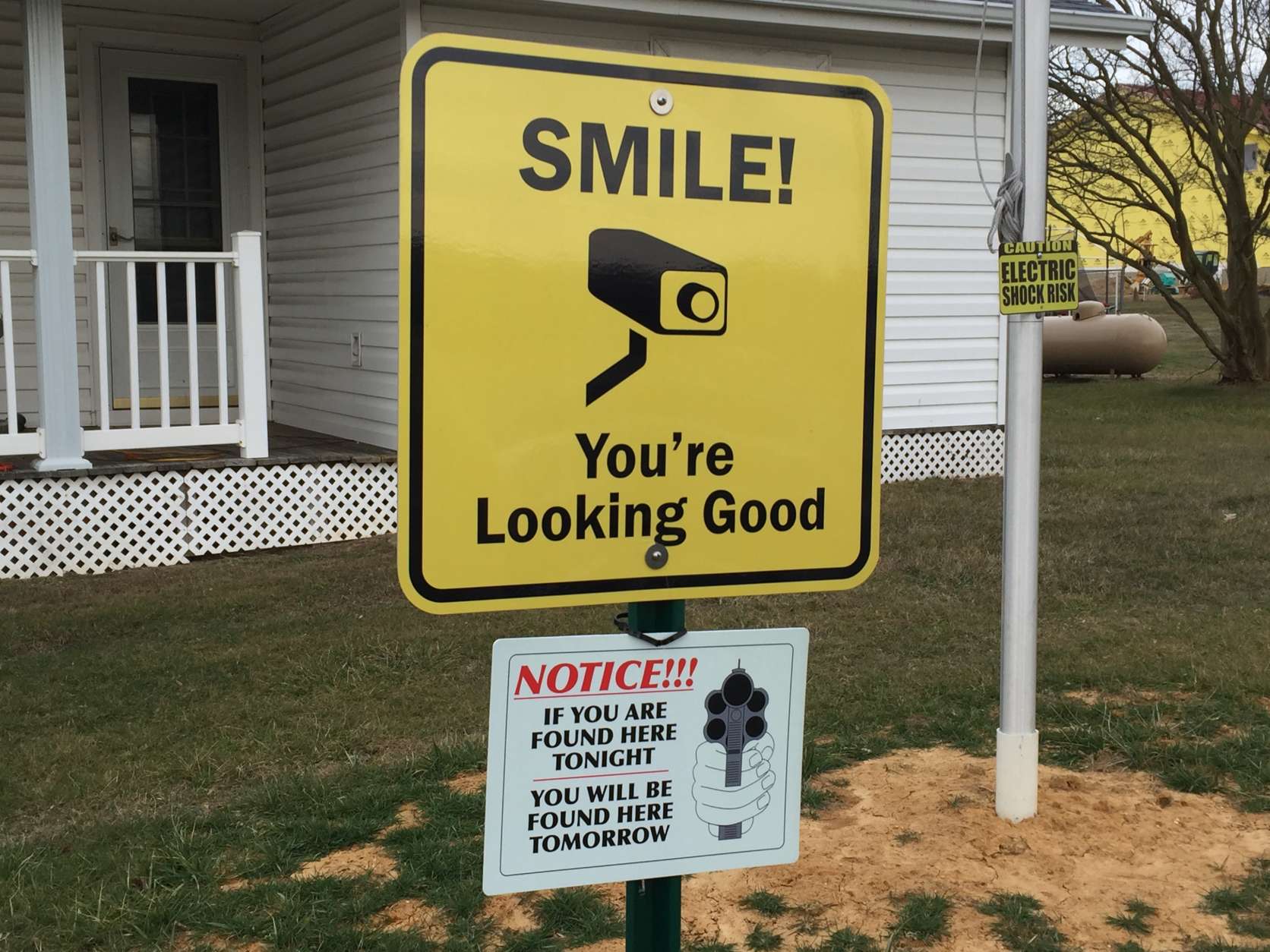 One of the signs in Dement's yard warning that anyone visiting her front yard will be caught on surveillance camera. (WTOP/Michelle Basch)
