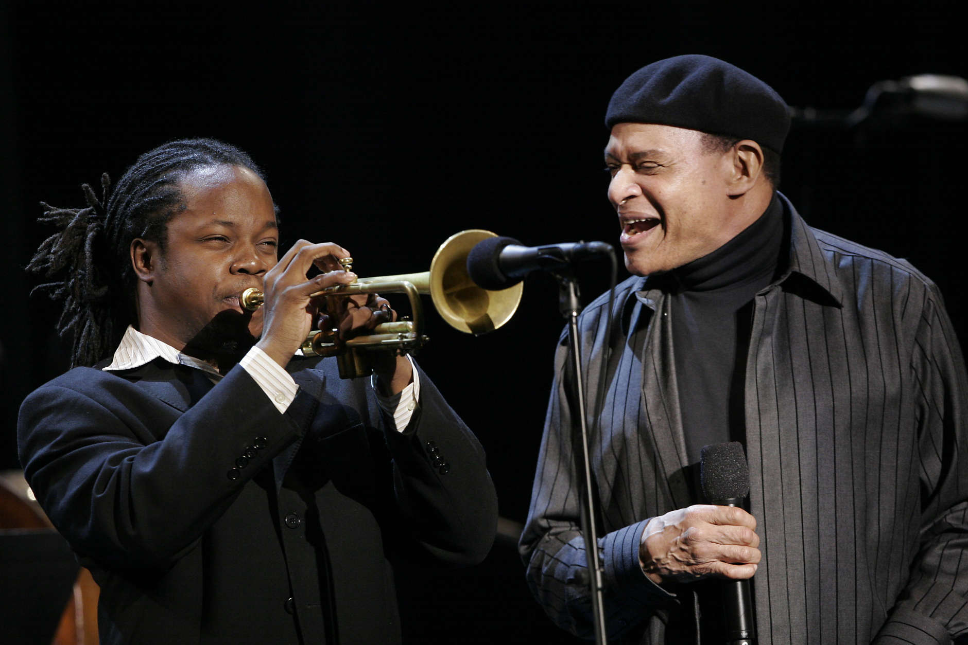 Al Jarreau, right, and Ambrose Akinmusire  perform during an all-star tribute concert for Herbie Hancock, Sunday, Oct. 28, 2007, in Los Angeles. The concert is part of the Thelonius Monk International Jazz competitio, which Akinmusire won.  (AP Photo/Rene Macura)