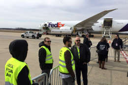 FedEx's "Panda Team" awaits for Bao Bao at Dulles International Airport on Tuesday, Feb. 21, 2107. The shipping company will fly the National Zoo-born giant panda in her own cargo plane, with a special panda decal, to Chengdu, China. Bao Bao will eventually join a breeding program. (WTOP/Kristi King)