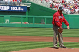 President Barack Obama winds up to deliver the first pitch of the Washington Nationals home opening baseball game against the Philadelphia Phillies, Monday, April 5, 2010, at Nationals Park in Washington. (AP Photo/Alex Brandon)