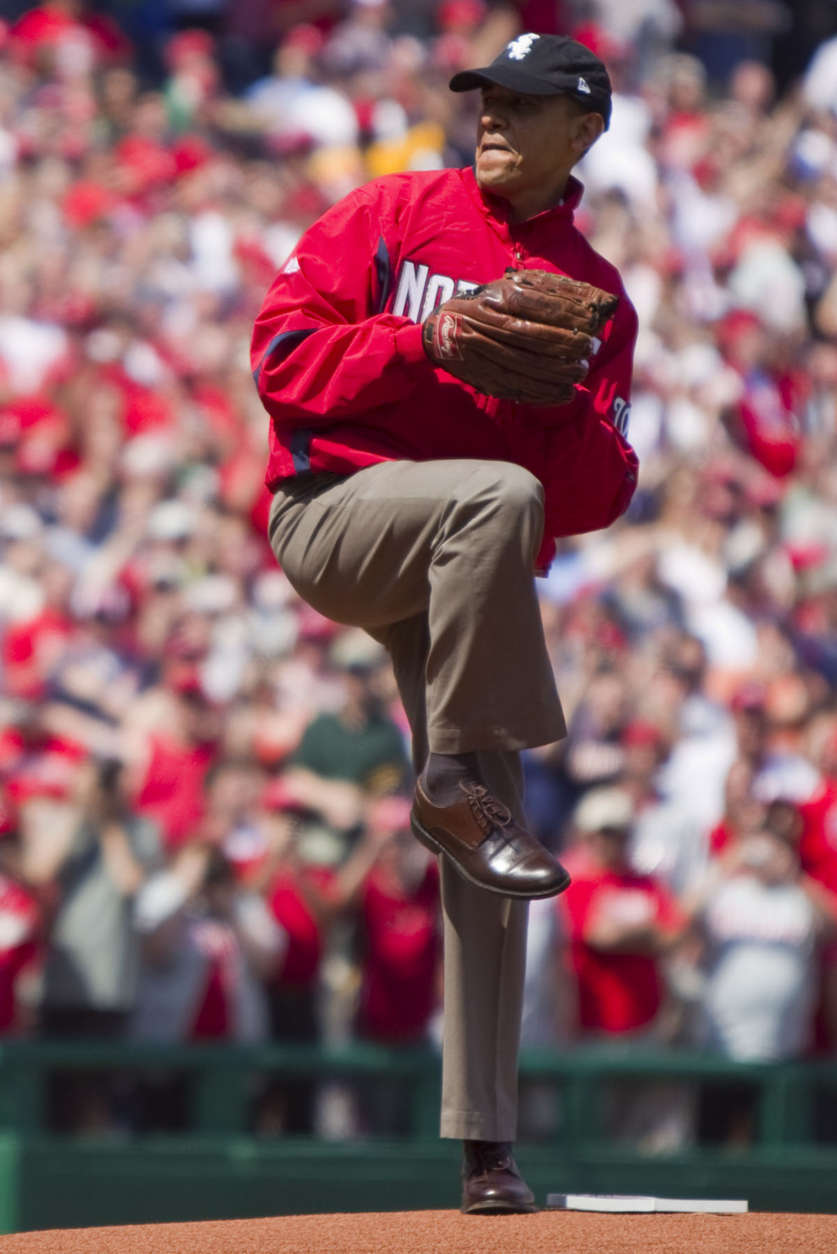 Wearing a Washington Nationals jacket and a Chicago White Sox hat, President Barack Obama delivers the first pitch of the Washington Nationals home opening baseball game against the Philadelphia Phillies, Monday, April 5, 2010, at Nationals Park in Washington. (AP Photo/Evan Vucci)