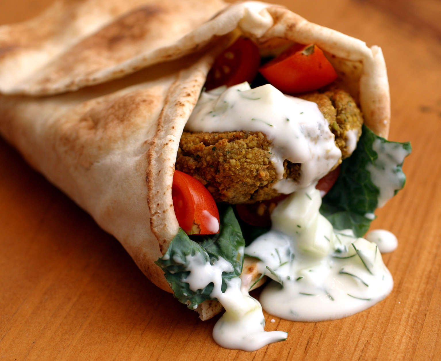 ** FOR USE WITH AP WEEKLY FEATURES **   The main course for a Greek-style vegetarian meal consists of a combination of falafel, strongly seasoned fried patties made from ground chickpeas, wrapped in a bed of greens and pita bread and doused with tzatziki yogurt sauce.  (AP Photo/Larry Crowe)