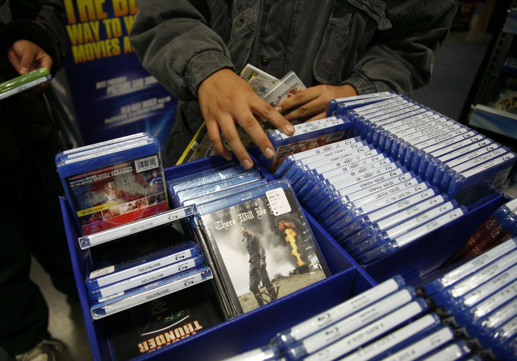 In this photo made Friday, Nov. 27, 2009, customers brows Blu-ray movies at Best Buy in West Hollywood, Calif. Although prices for some Blu-ray players dropped below $100 this holiday season, customers are hesitating to jump into the next-generation video format. (AP Photo/Jason Redmond)