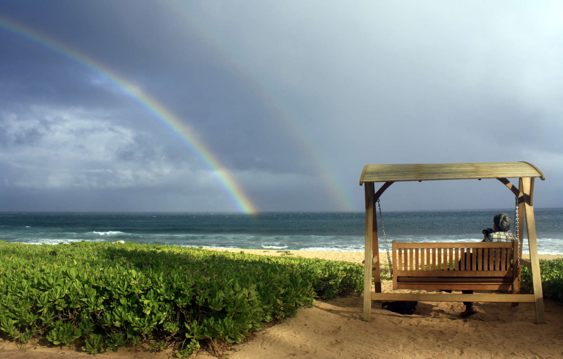 This July 2, 2010 photo shows Joseph Heher photographing rainbows at Shipwreck's Beach, Grand Hyatt Kauai in Hawaii.  A good way to see the sights, and get your own photo souvenirs, while on vacation is to sign up for a guided photo tour.   (AP Photo/Ashley Heher)