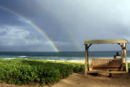 This July 2, 2010 photo shows Joseph Heher photographing rainbows at Shipwreck's Beach, Grand Hyatt Kauai in Hawaii.  A good way to see the sights, and get your own photo souvenirs, while on vacation is to sign up for a guided photo tour.   (AP Photo/Ashley Heher)