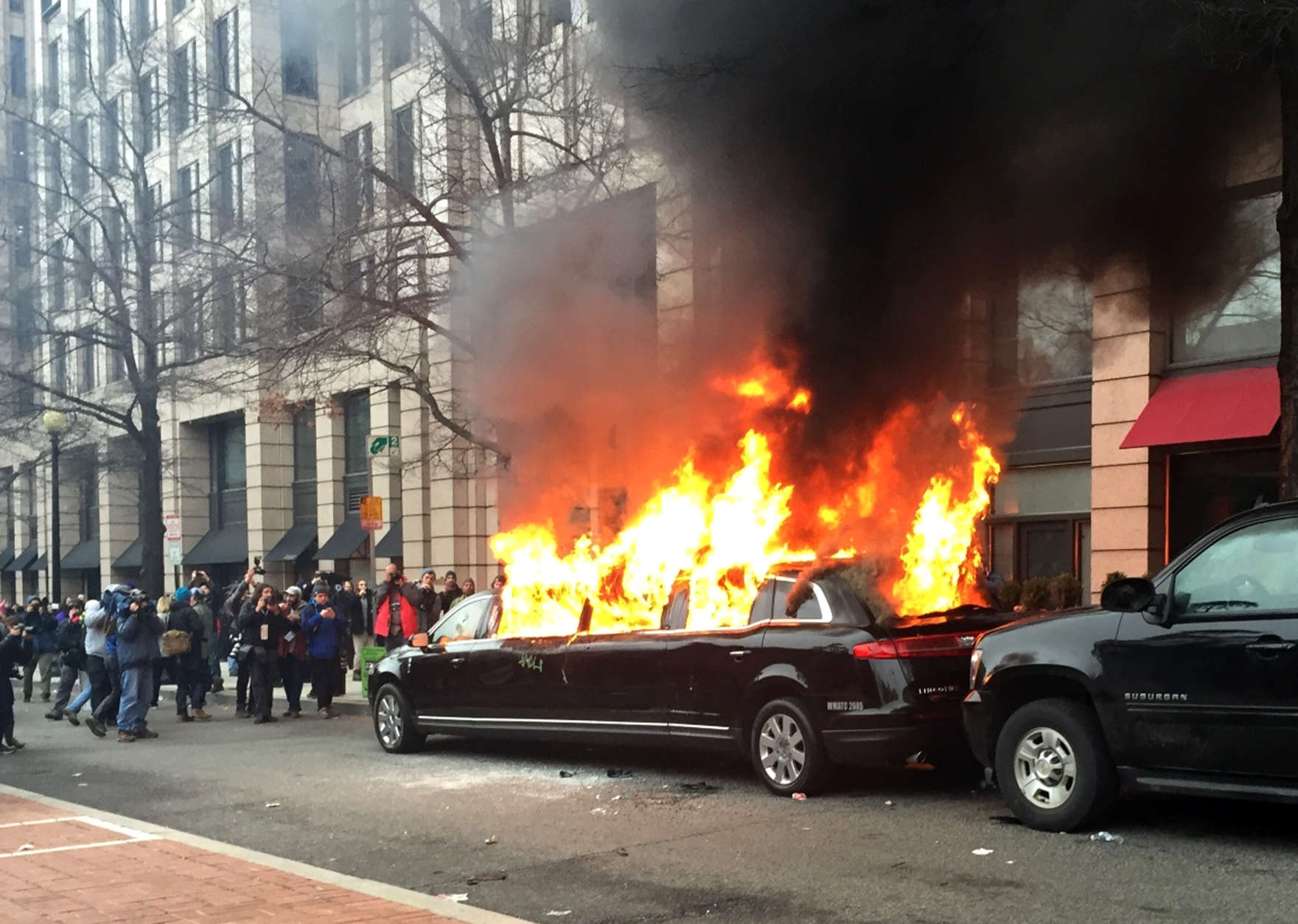 Protesters set a parked limousine on fire in downtown Washington, Friday, Jan. 20, 2017, during the inauguration of President Donald Trump. 
(AP Photo/Juliet Linderman)