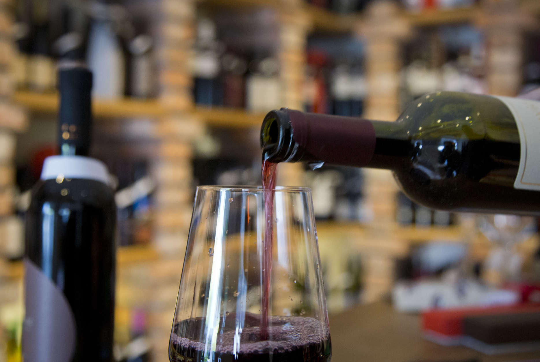 Red wine is poured into a glass at a wine shop in Zagreb, Croatia, Wednesday, March 1, 2017. Slovenian winemakers have warned the EU that Croatia has presented "forged" documents while getting a permission to use the Teran wine brand in the 28-nation bloc. Neighboring EU members Slovenia and Croatia have long been at odds over the use of the Teran red wine name. (AP Photo/Darko Bandic)