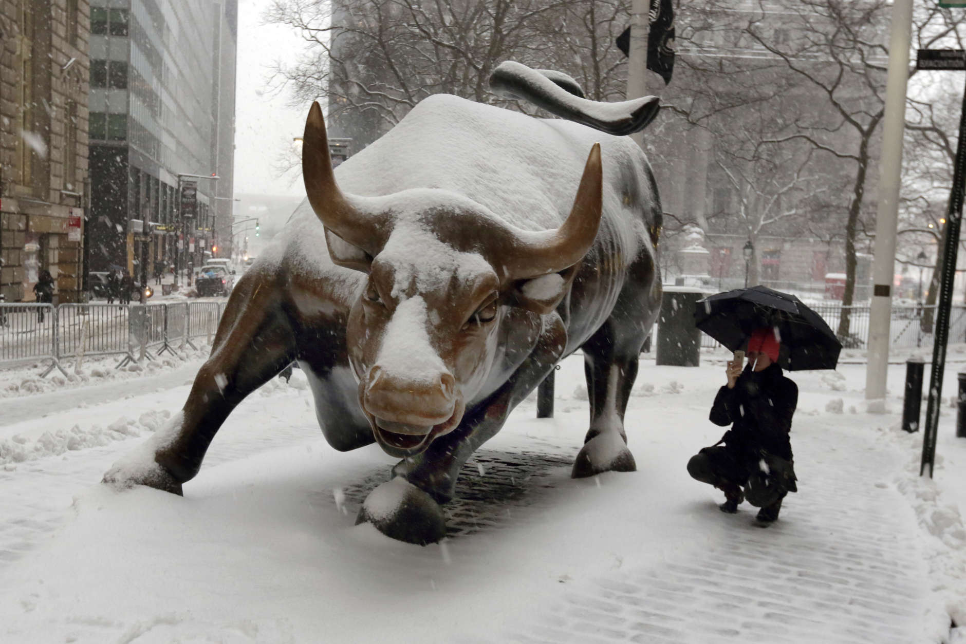 The "Charging Bull" statue is covered in snow in New York's Financial District, Tuesday, March 14, 2017. New York Gov. Andrew Cuomo has declared a state of emergency Tuesday for all of New York's 62 counties, including New York City's five boroughs. (AP Photo/Richard Drew)