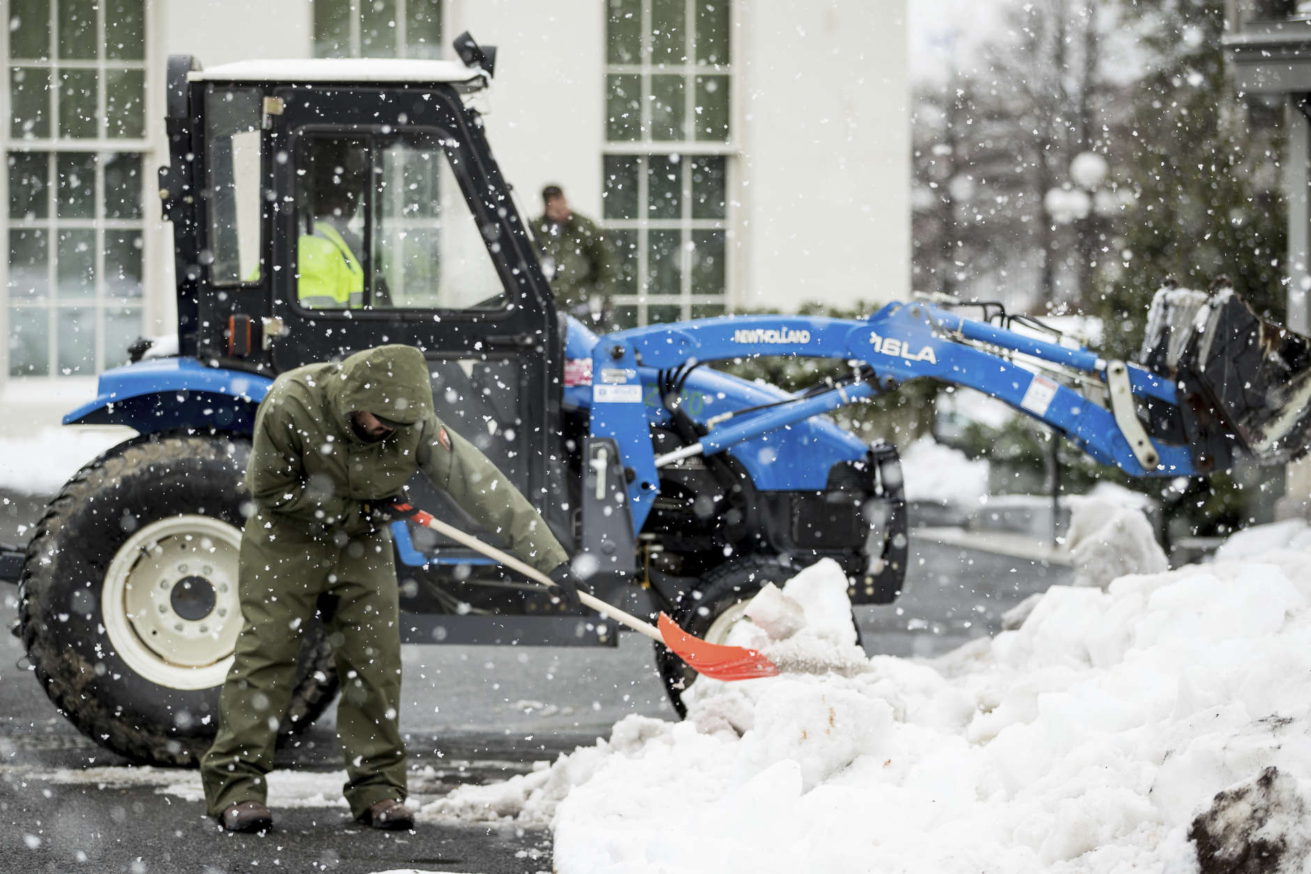 Workers clear snow outside the West Wing of the White House in Washington, Tuesday, March 14, 2017. A sloppy, blustery late-season storm lashed the Northeast with sleet and more than a foot of snow in places, paralyzing much of the Washington-to-Boston corridor after a remarkably mild February had lulled people into thinking the worst of winter was over. (AP Photo/Andrew Harnik)
