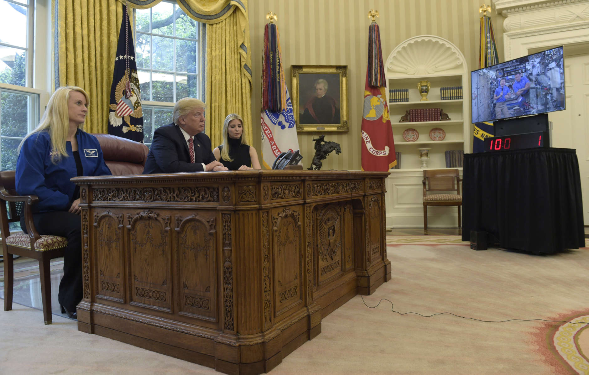 President Trump — flanked by astronaut Kate Rubins as well as daughter and adviser Ivanka Trump — speaks April 24 with astronauts Peggy Whitson and Jack Fischer (who are aboard the International Space Station). (AP Photo/Susan Walsh)
