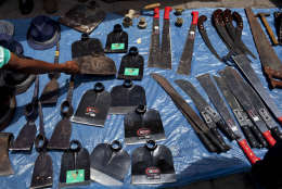 Fieldwork tools along with gentlemen's hats are displayed for sale on a blue tarp by a street vendor in Santiago Atitlan, Guatemala, Wednesday, July 25, 2012.  (AP Photo/Rodrigo Abd)