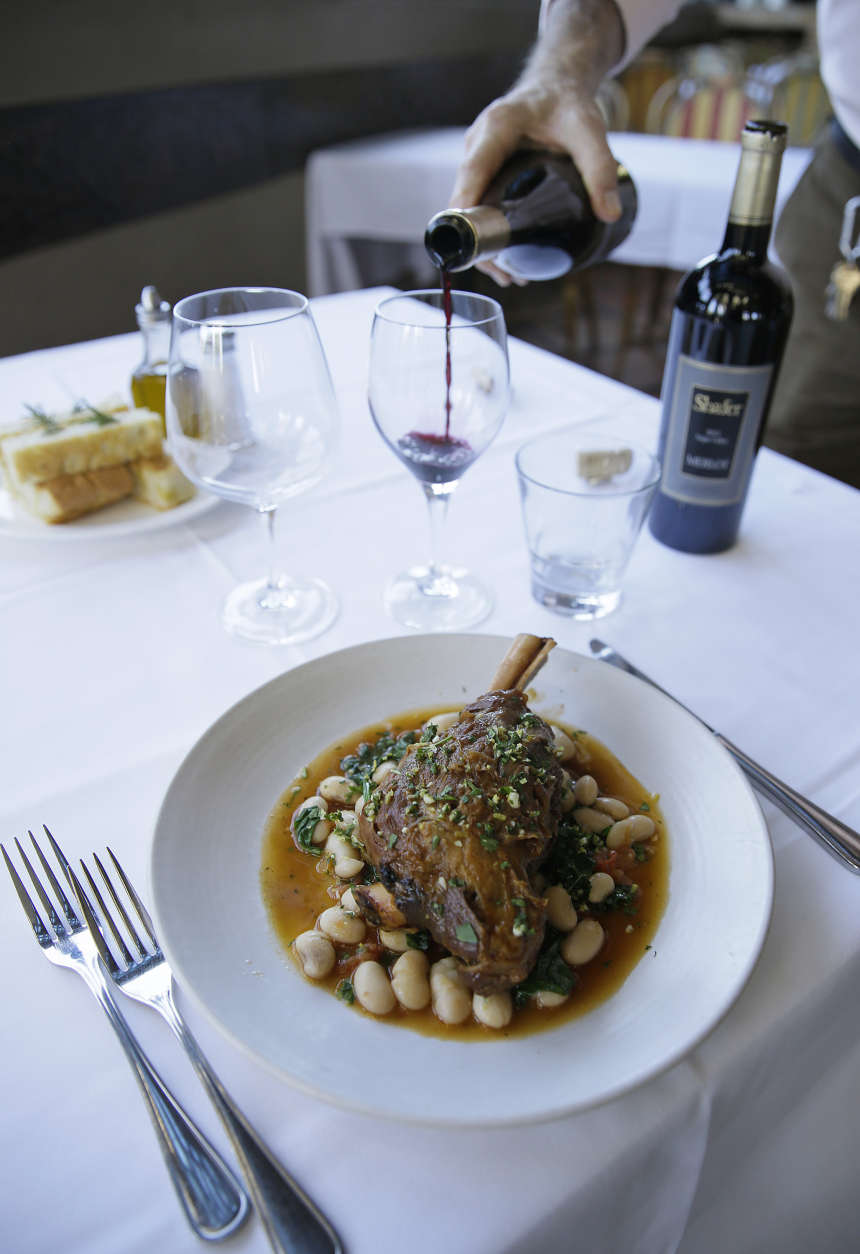 In this photo taken Monday, Feb. 1, 2016, a lamb shank dish with a Tuscan bean ragu, natural jus and gremolata is paired with Shafer Merlot and Relentless wines at the Bistro Don Giovanni restaurant in Napa, Calif. Theres some debate over whether red with beef and white with chicken and pork is an absolute or a rule made to be broken. (AP Photo/Eric Risberg)