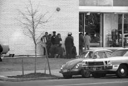 Police and rescue workers give first aid to a victim outside BNai BRith in Washington on Wednesday, March 9, 1977. Gunmen have taken hostages inside. (AP Photo)
