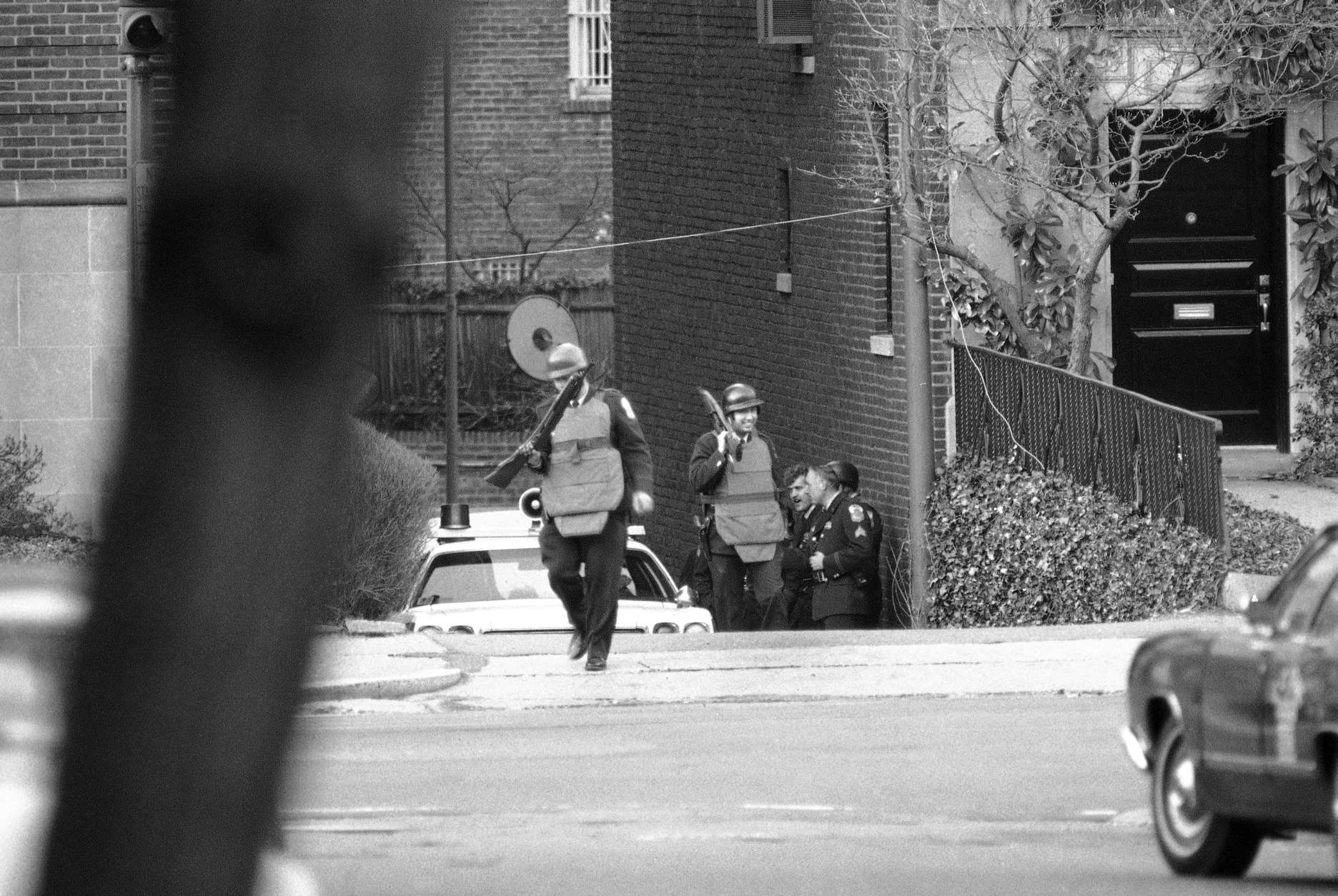 Heavily armed police wearing protective vests arrive at their post near the Islamic center in Northwest Washington on Thursday, March 10, 1977 to relieve others who had been on duty all night watching the center where gunmen held hostages. It is one of three buildings in the capital where armed terrorists, believed to be members of the Hanafi Muslim sect, were holding hostages. (AP Photo)