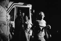 An unidentified woman jumps off a bus at the Foundry Methodist Church in Washington, D.C., on Friday, March 11, 1977 following her release by gunmen. Twelve black Hanafi Moslems held some 134 hostages in three Washington buildings for 38 hours before surrendering to police on Friday. (AP Photo)