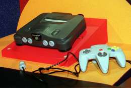 The newly unveiled Nintendo 64 video, the world's first true 64-bit home video game, is displayed during a news conference  Wednesday, May 15, 1996, in Los Angeles. The introduction of the Nintendo system will be a big event as developers and marketers gather in Los Angeles for the Electronic Entertainment Expo. Nintendo 64 will be available for a manufacturer's suggested retail price of $249.95. (AP Photo/Kevork Djansezian)