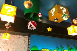 At Mockingbird Hill, red and white “piranha plants” drop down from green pipes and boxes marked with question marks light up. A cheerful voice that says, “It’s me! Mario!” comes over the speaker.  (WTOP/Rachel Nania)