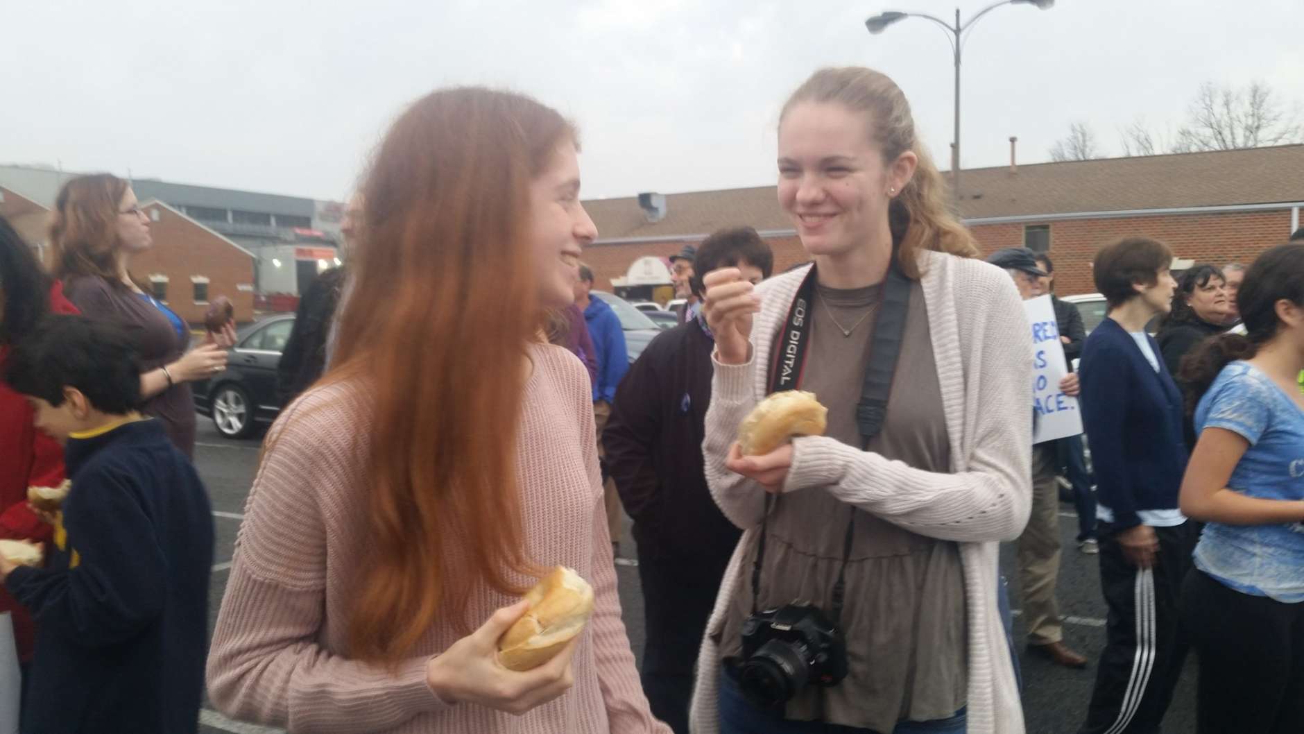 Tenth graders Emily Schrader and Anna O'Keefe at Wednesday's Bagels Not Bombs event. (WTOP/Kathy Stewart)