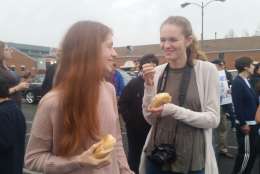 Tenth graders Emily Schrader and Anna O'Keefe at Wednesday's Bagels Not Bombs event. (WTOP/Kathy Stewart)