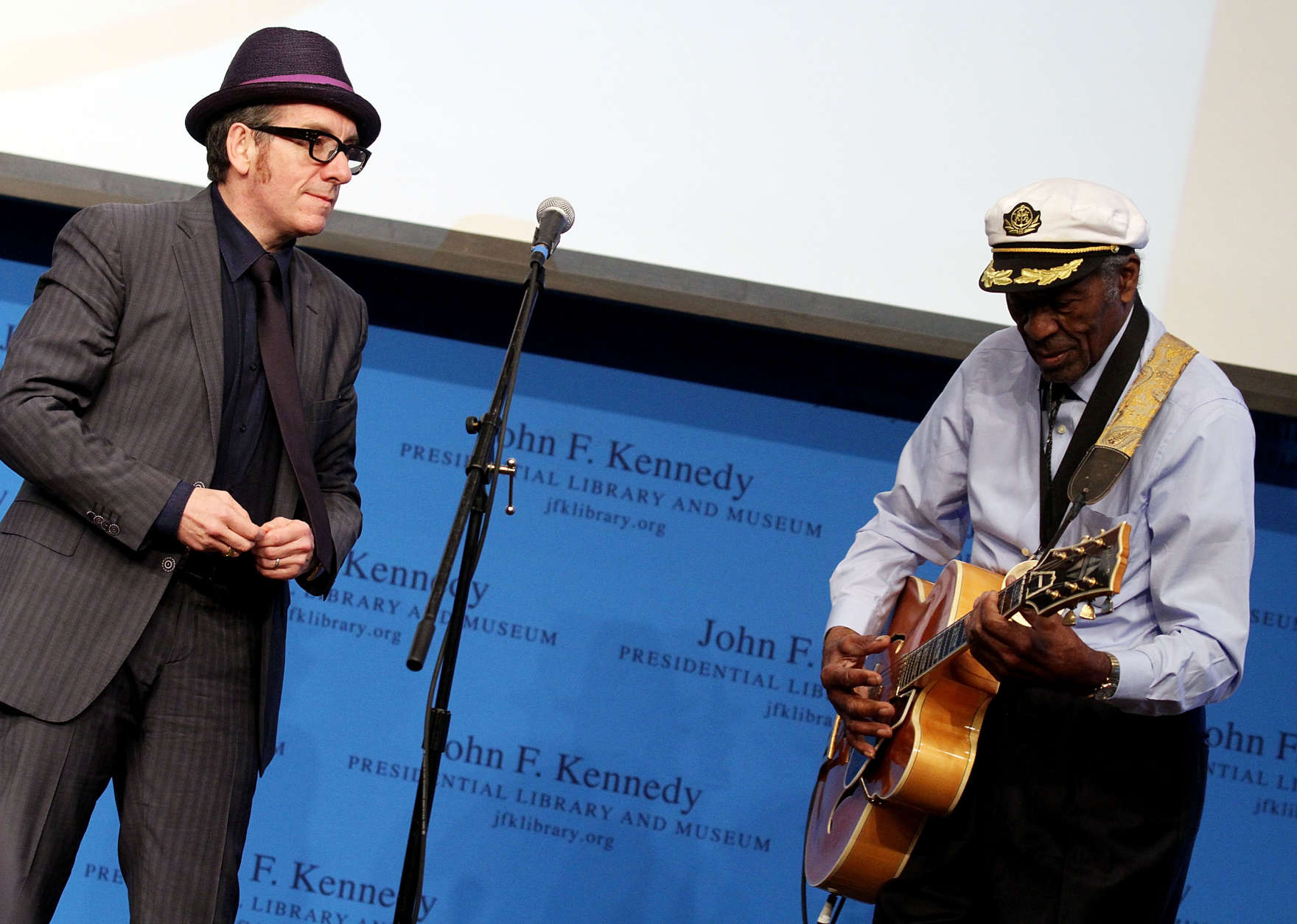 Boston, MA - FEBRUARY 26: Elvis Costello watches at honoree Chuck Berry performs during the 2012 Awards for Lyrics of Literary Excellence at The John F. Kennedy Presidential Library And Museum on February 26, 2012 in Boston, Massachusetts. (Photo by Marc Andrew Deley/Getty Images)