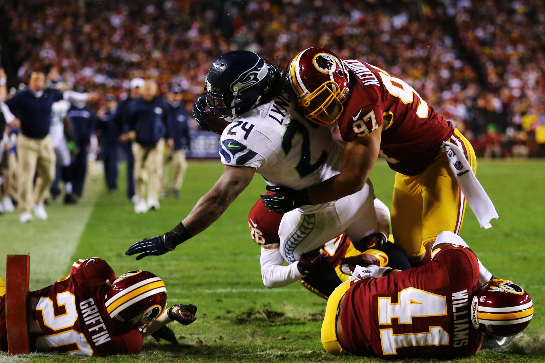 LANDOVER, MD - JANUARY 06:  Marshawn Lynch #24 of the Seattle Seahawks scores a fourth quarter touchdown against the defense of  Lorenzo Alexander #97 of the Washington Redskins during the NFC Wild Card Playoff Game at FedExField on January 6, 2013 in Landover, Maryland.  (Photo by Al Bello/Getty Images)