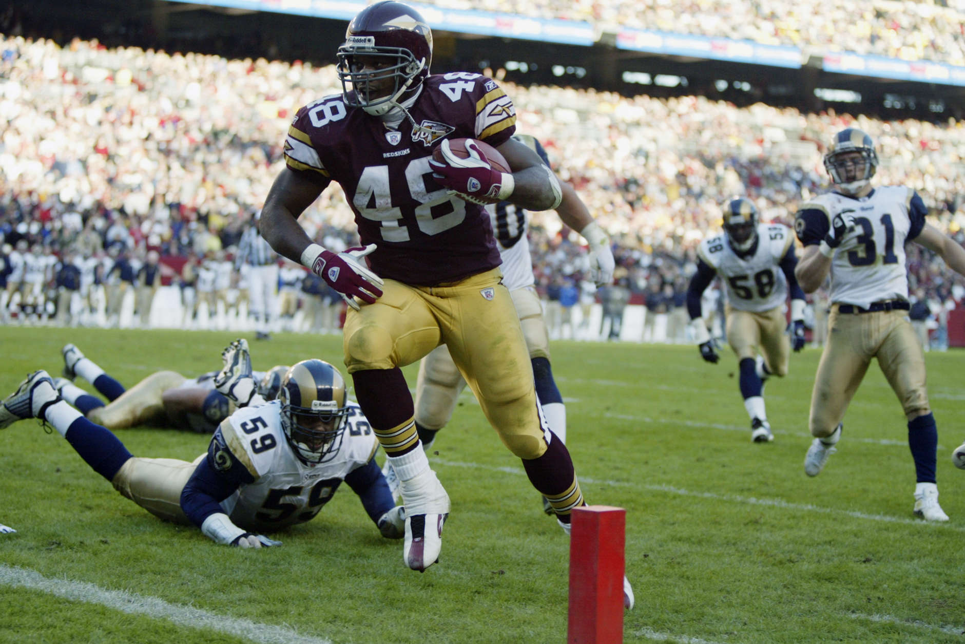 LANDOVER, MD - NOVEMBER 24:  Stephen Davis #48 of the Washington Redskins runs for a touchdown against the St. Louis Rams on November 24, 2002 at FedEx Field in Landover Maryland.  Davis had touchdown runs of one, three and five yards on the day as the Redskins defeated the Rams 20-17.  (Photo by Al Bello/Getty Images)