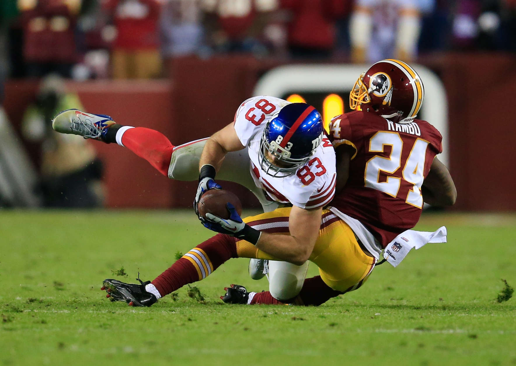 LANDOVER, MD - DECEMBER 01: Tight end Brandon Myers #83 of the New York Giants is tackled by strong safety Bacarri Rambo #24 of the Washington Redskins after catching a fourth quarter pass during the Giants 24-17 win at FedExField on December 1, 2013 in Landover, Maryland.  (Photo by Rob Carr/Getty Images)